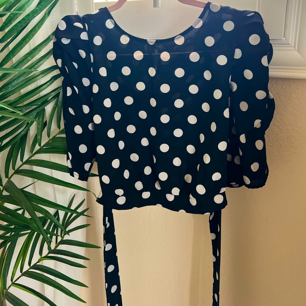 Black polka-dot blouse.